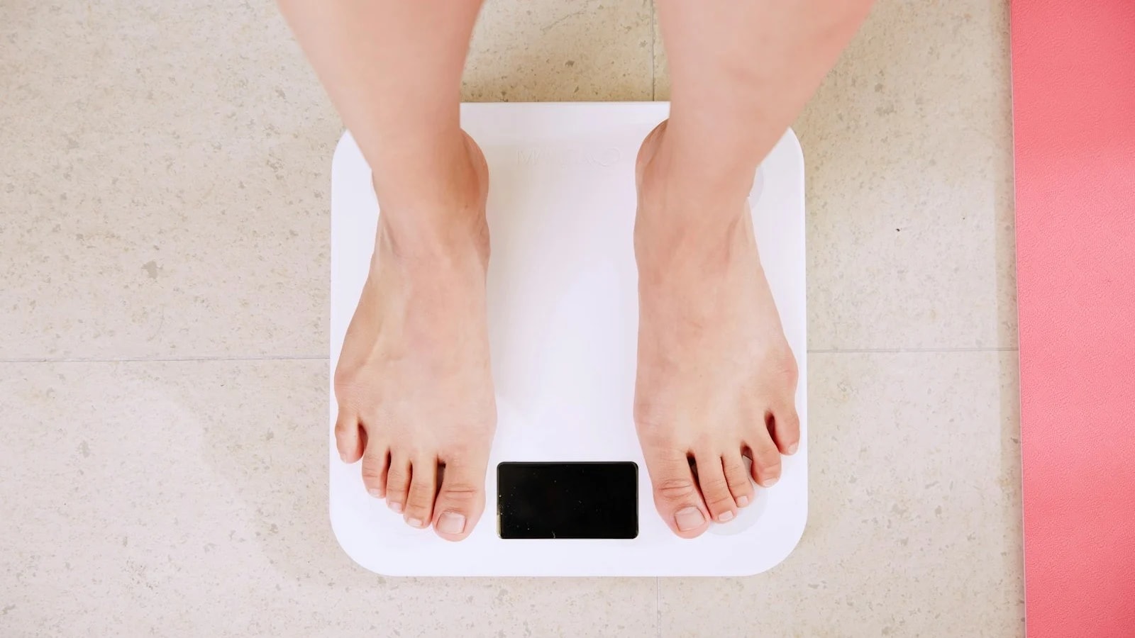 Bare feet on a white digital bathroom scale
