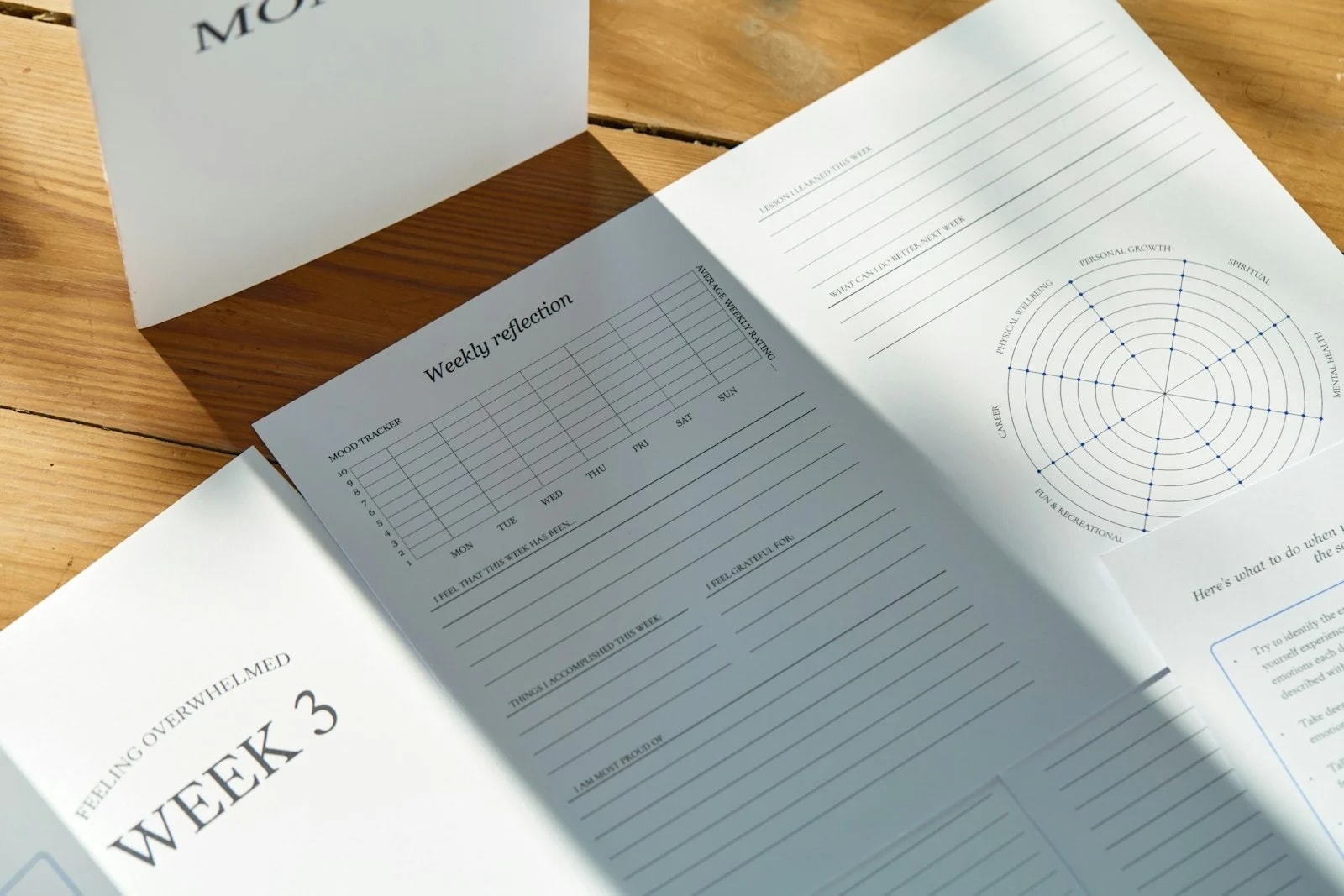 An open weekly planner on a wooden table in sunlight