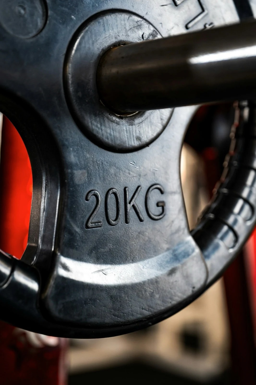 Close-up of a 20 kg weight plate on a barbell