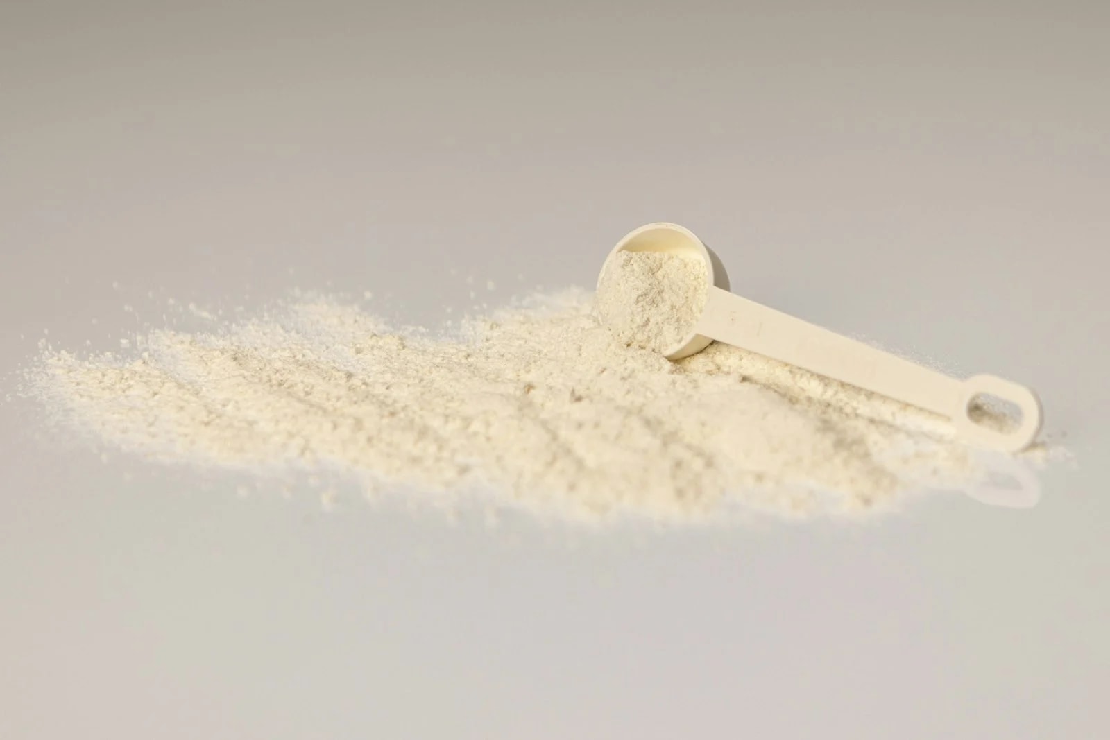 A small measuring scoop lying in a line of pale powder